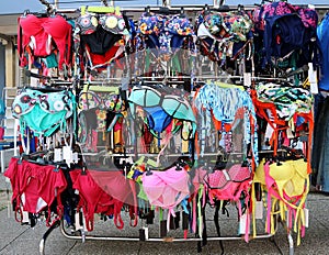 Women`s swimwear on a hanger outside a shop near the beach