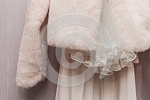 Women`s white cape made of artificial fur wool wedding element fragment object clothes of the bride