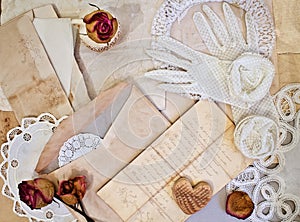 Women's white gloves and old letters.