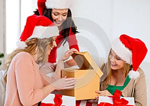 Women in santa helper hats with many gift boxes