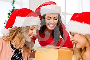 Women in santa helper hats with many gift boxes