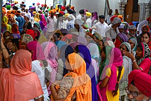 Women in saree praying at the Golden Temple