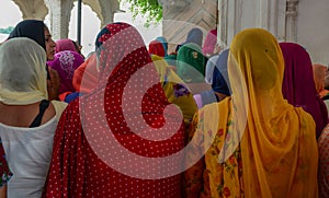 Women in saree praying at the Golden Temple