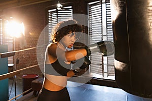 Women self defense girl power. African american woman fighter training punches on boxing ring. Healthy strong girl