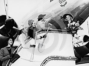 Women sending off friend boarding plane