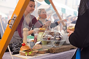 Women serving hamburgers on food festival in Ljubljana, Slovenia.