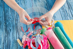 Women sews by hand and making handmade heart