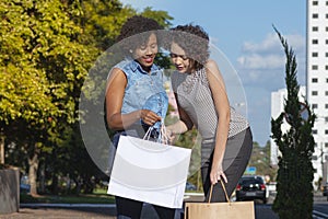 Women with shopping bags during city tou