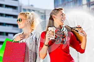 Women shopping in city with bags