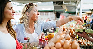 Women shopping fresh eggs at local farmer market