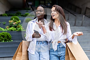 Women in shopping. Two happy women with shopping bags enjoying in shopping, haning fun in the city. Consumerism, shopping,