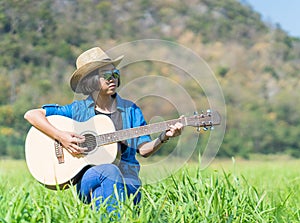 Women short hair wear hat and sunglasses sit playing guitar in g