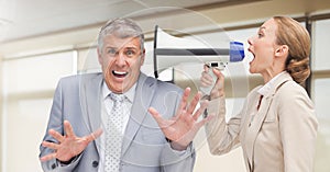 Women shouting at Stressed businessman in office
