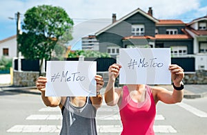 Women showing poster with metoo hashtag