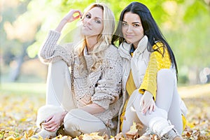 Women sitting in autumn park