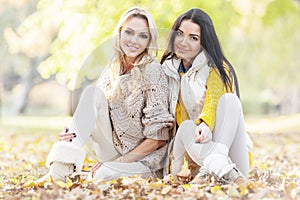 Women sitting in autumn park