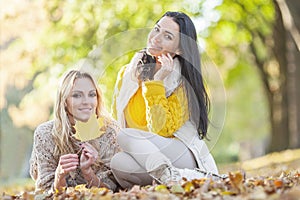 Women sitting in autumn park