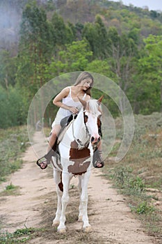 Women on skirt dress Riding Horses On field landscape Against forest.