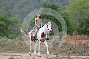 Women on skirt dress Riding Horses On field landscape Against forest.