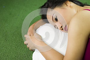 Women sleep on the green grass, a beautiful and dreamy Thai woman laying down on green grass, relaxing