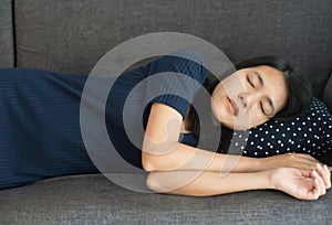 Women sleeping on sofa bed and grinding teeth,Female tiredness and stress at living room photo