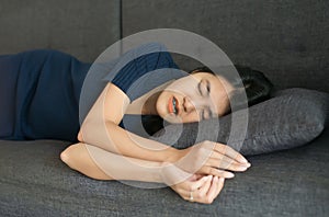 Woman sleeping on sofa and grinding teeth,Female tiredness and stress at home photo