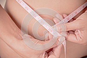 Women Slim waist with a tape measure around it