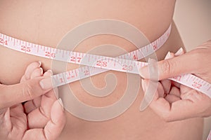 Women Slim waist with a tape measure around it