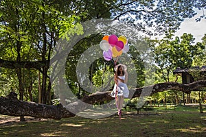 Women are smiling, sitting holding a transparent ball under the tree. photo