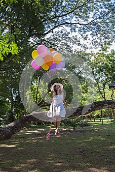 Women are smiling, sitting holding a transparent ball under the tree. photo