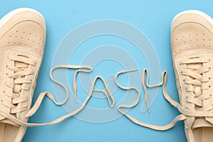Women sneakers with laces in stash text.