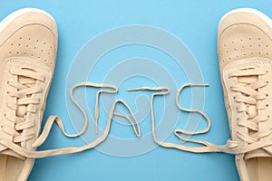 Women sneakers with laces in stats text.