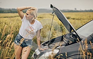 Women spection She opened the hood Broken car on the side See engines that are damaged or not