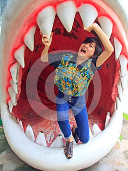 Women standing in jaws of shark photo