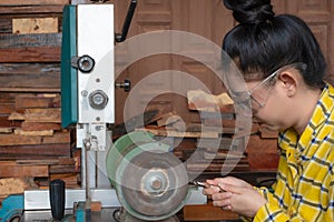 Women standing is sharpen drill at a work bench with  Whetstone Machine