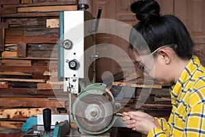 Women standing is sharpen drill at a work bench with  Whetstone Machine