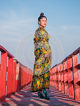 Women standing on a wooden bridge