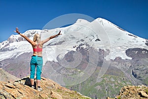 A women stands on top of Mount Elbrus