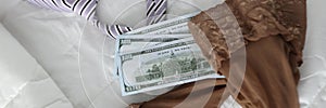 Women stockings men tie and cash dollar bills