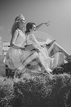 Women in straw wreaths and white dresses