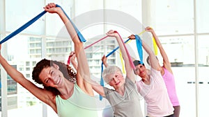 Women stretching resitance bands at a fitness class