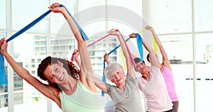 Women stretching resitance bands at a fitness class