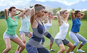 Women, stretching and squats for exercise outdoor, team and ready for workout with health and wellness. Training