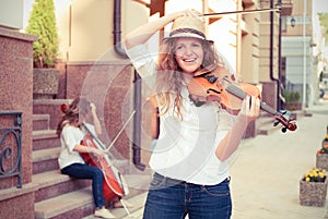 Women strings duet playing violin