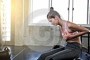 Women suffering from chest pain. Female touching her chest with hands while exercise. Asian girl. Beautiful women in sportswear