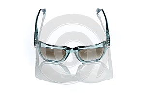 Women sunglass in sunlight on white background. Modern stylish sunglasses for holiday vacation. Fashion female blue
