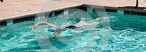 Women swimming laps in a outdoor pool