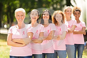 Women In T-Shirts With Pink Ribbons Standing In Line Outdoor