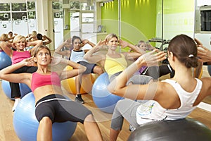 Women Taking Part In Gym Fitness Class