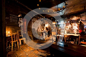 Women talking inside the old style bar with vintage furniture